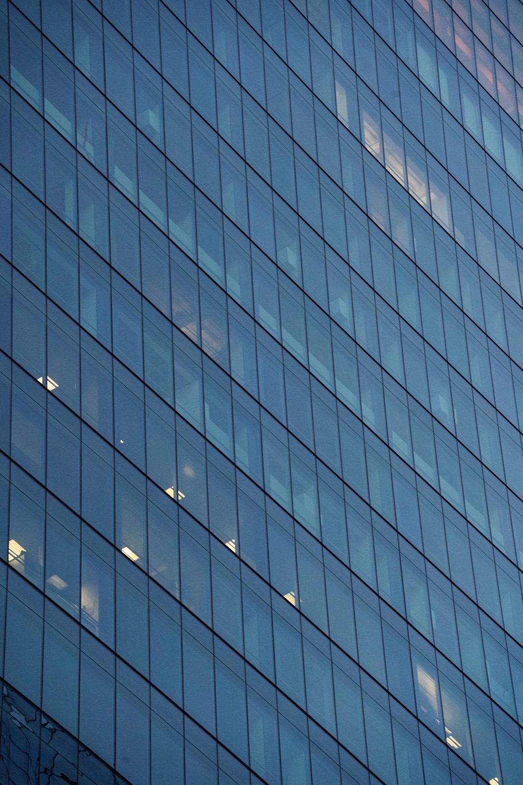 Blue glass curtain-wall facade of a commercial building